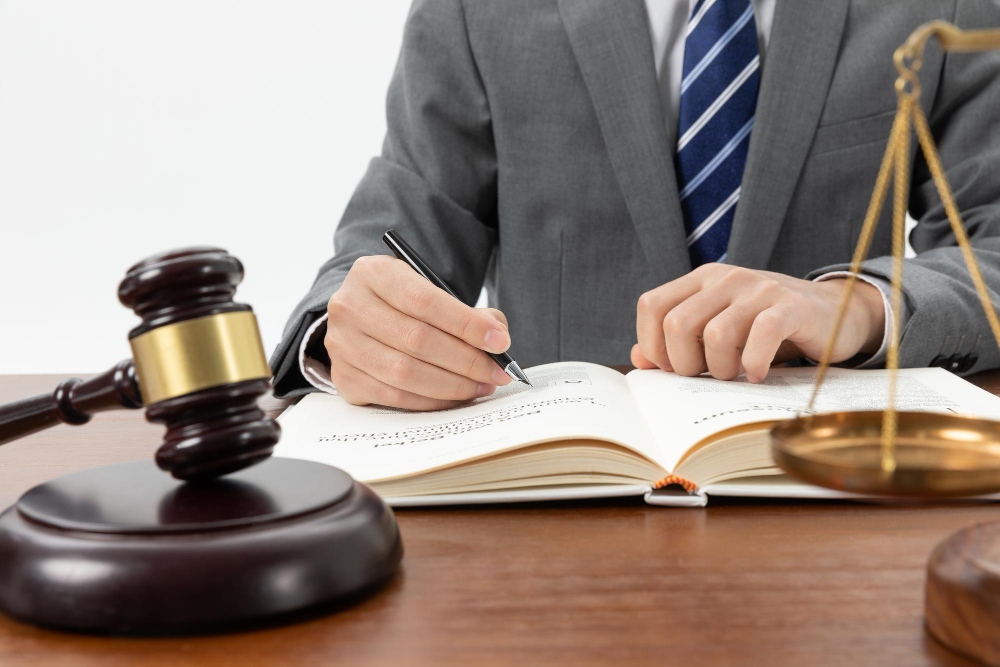 outsourced legal service in UAE a person in the suit writing on the book