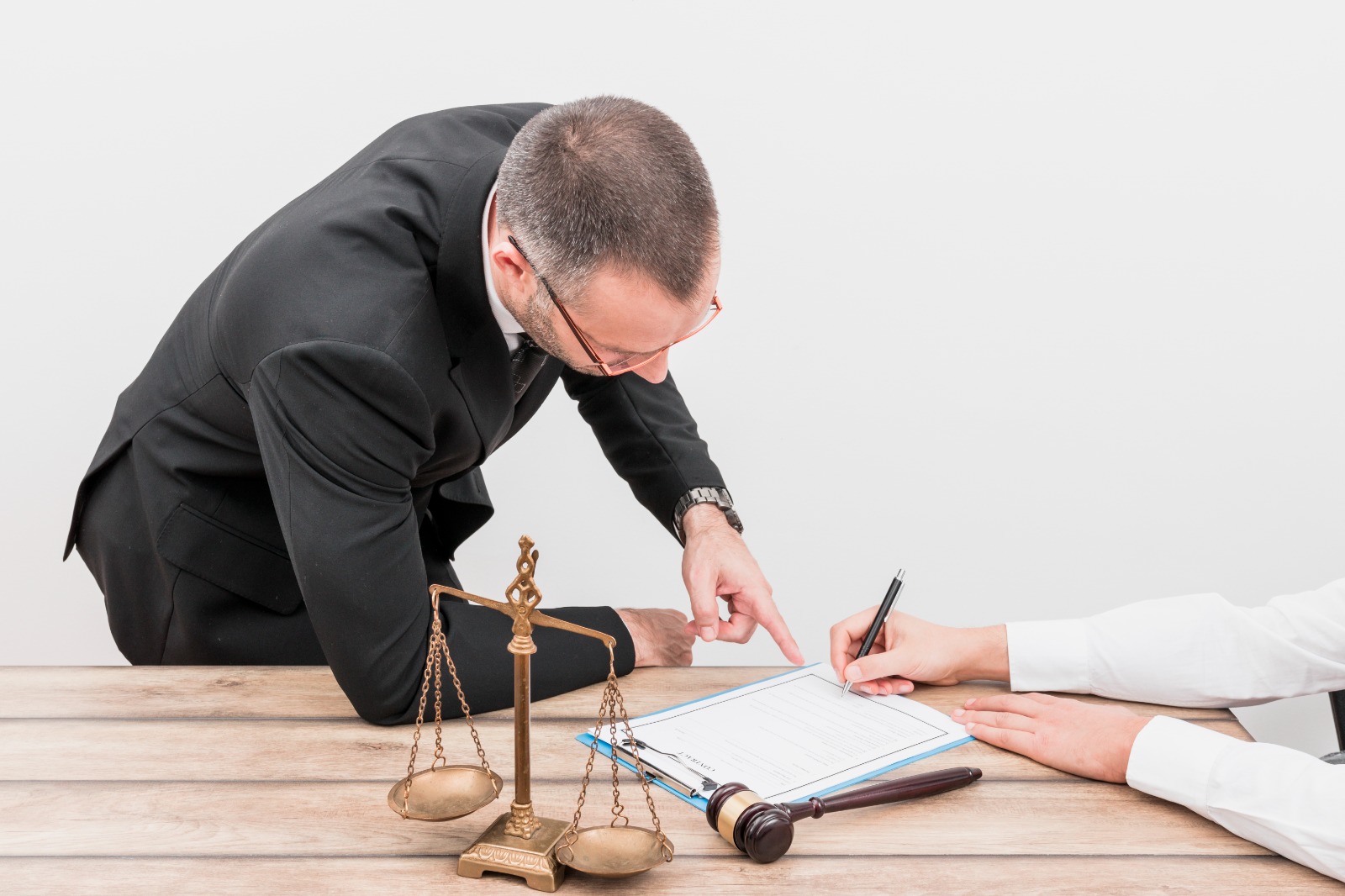 a person pointing to a paper that another person who was writing