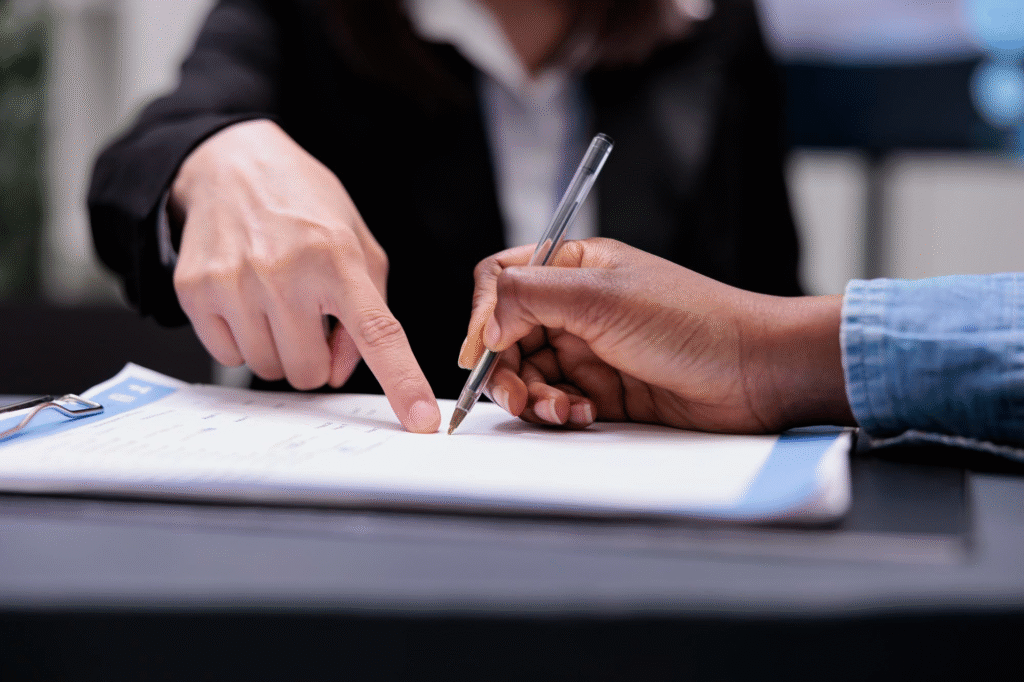 two persons signing contract of real estate deal 