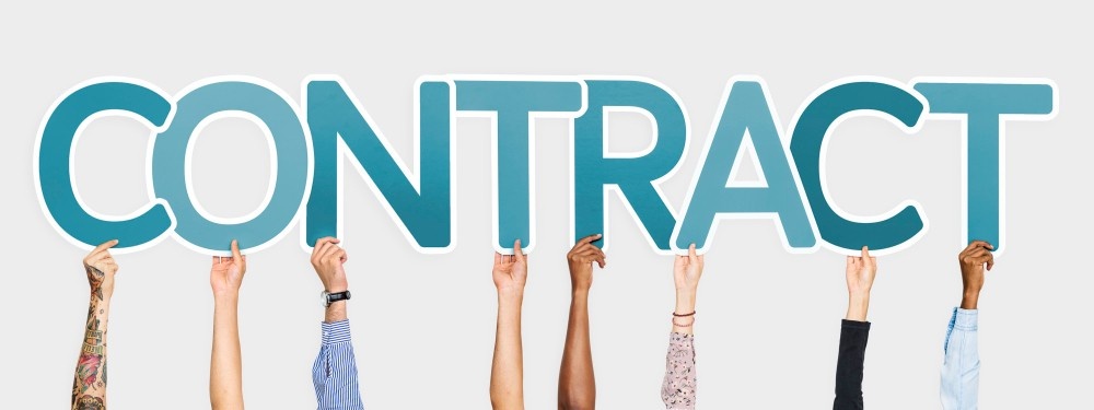 hands holding letters of contract